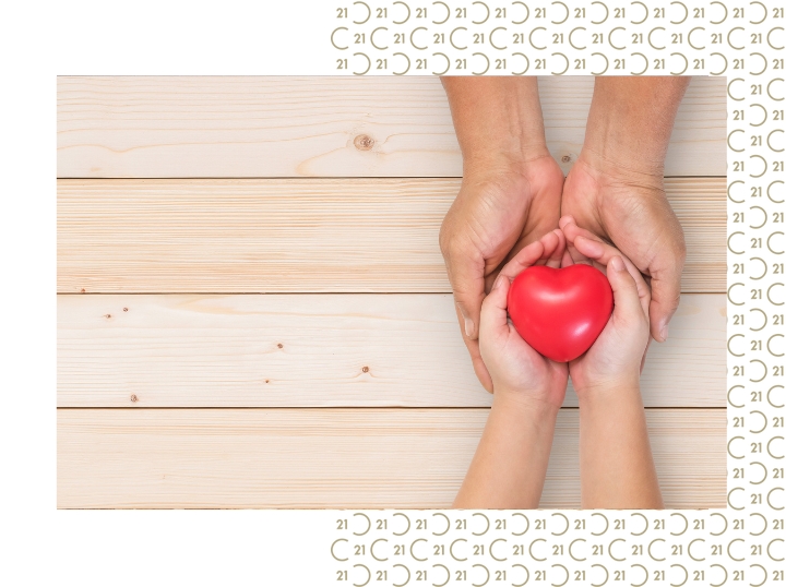 image of two hands holding a red heart symbol of giving